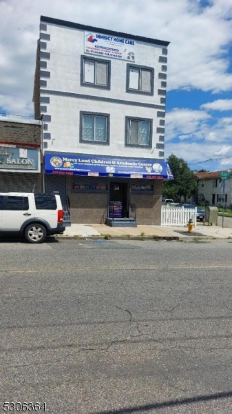 a view of building with car parked