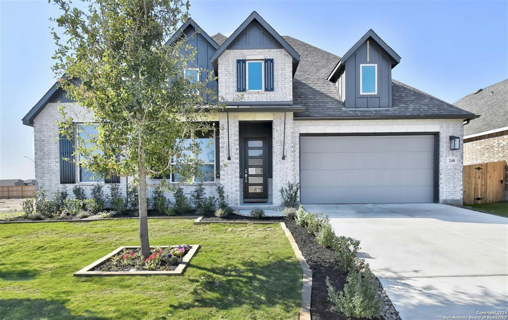 a front view of a house with garden