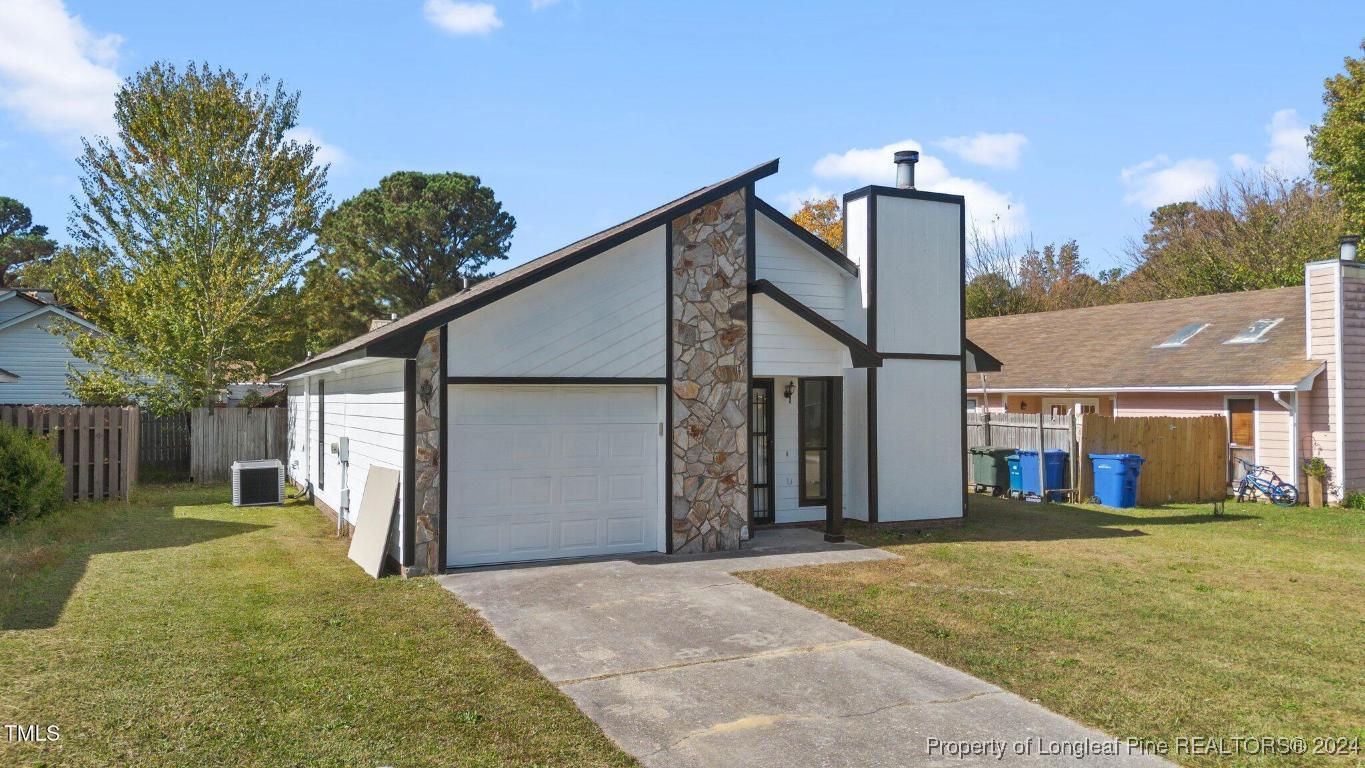 a view of a house with a yard and garage