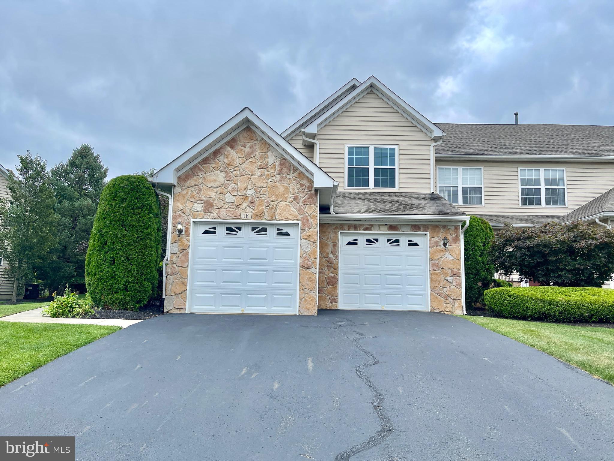 a view of front of house with yard and garage