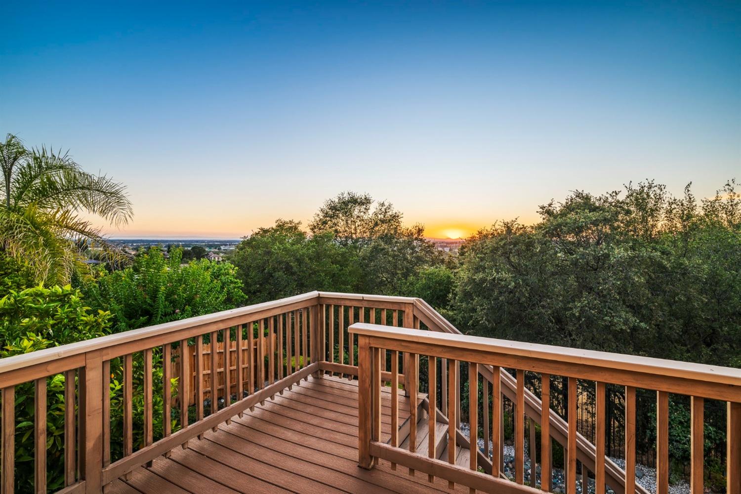 a view of balcony with wooden floor and fence