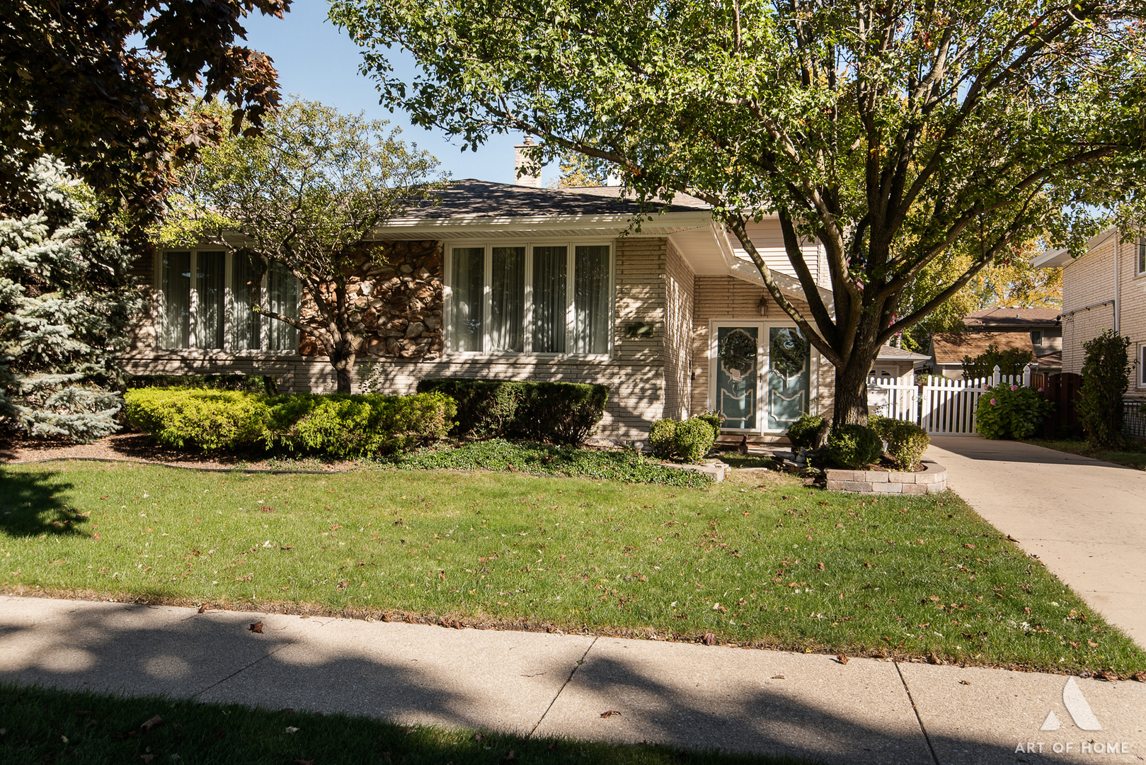 a front view of a house with a yard table and chairs