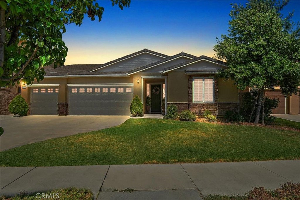 a front view of a house with a yard and garage