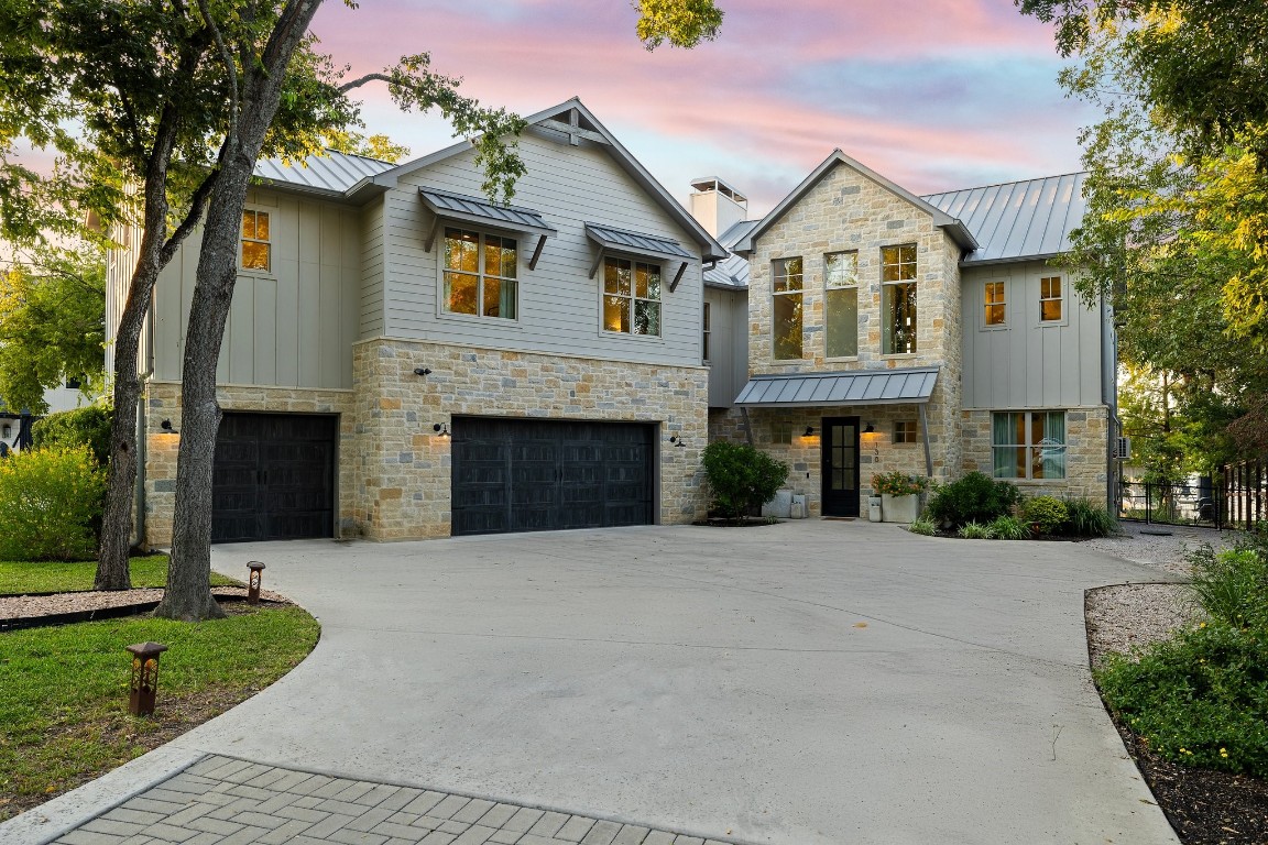 a front view of a house with yard and tree