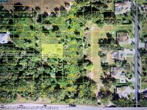 an aerial view of residential house with outdoor space and trees all around