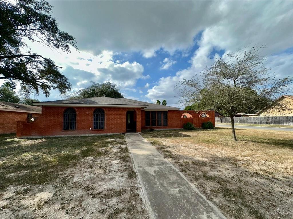 Ranch-style home featuring a front yard