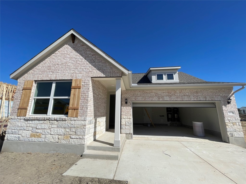 a front view of a house with a garage