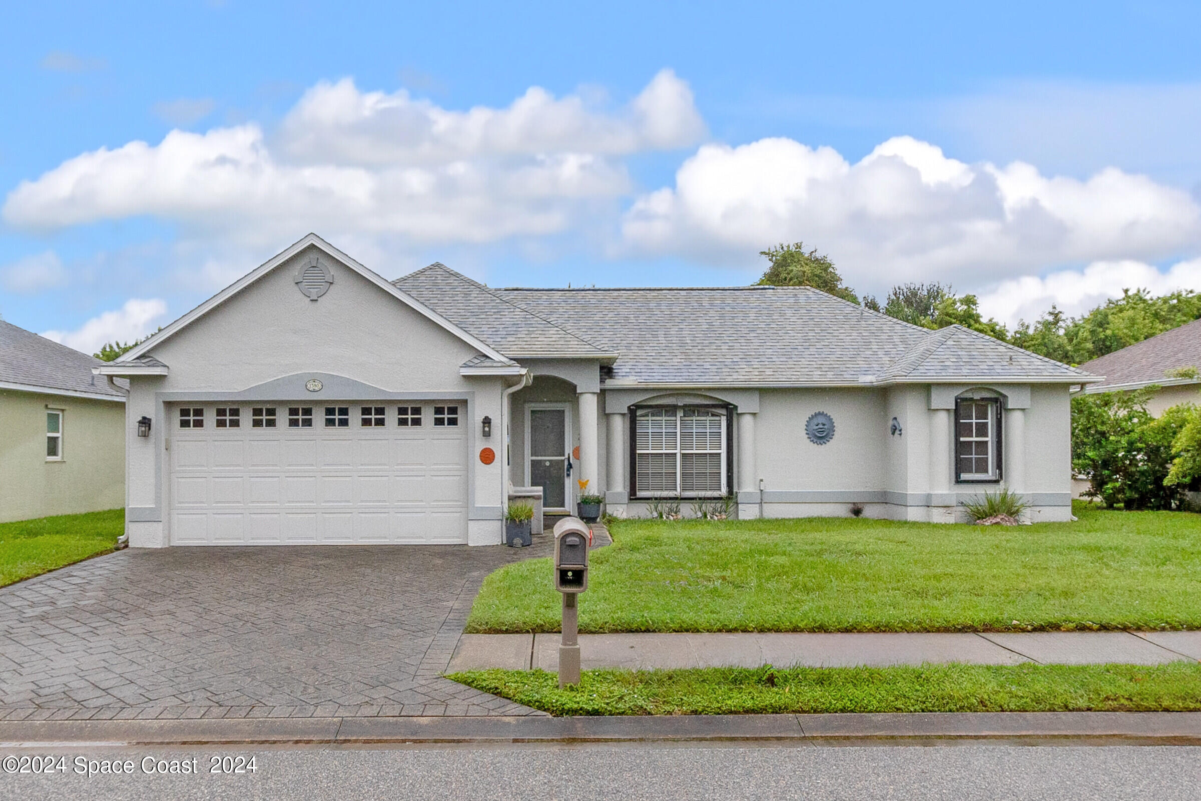 a front view of a house with a yard and garage