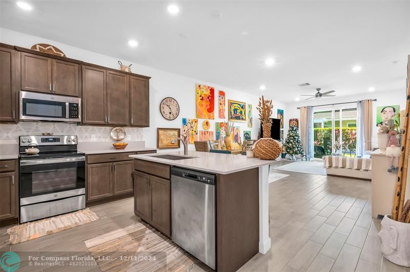 a kitchen with stainless steel appliances granite countertop a stove and a sink