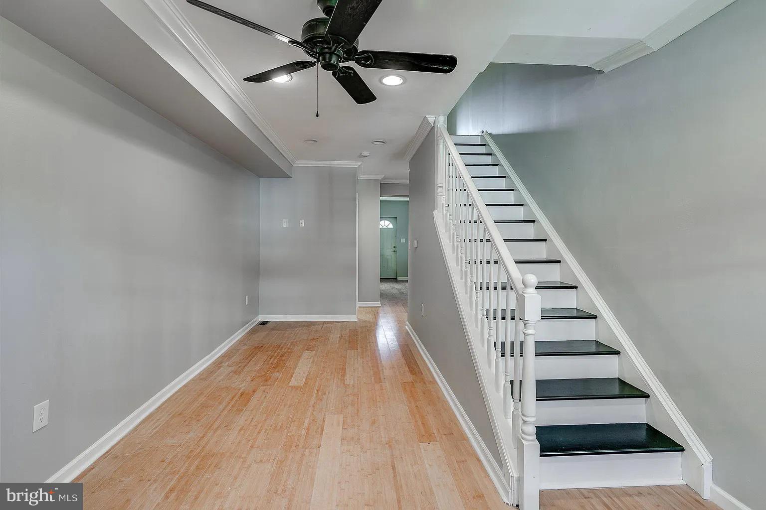 wooden floor in an empty room with a staircase