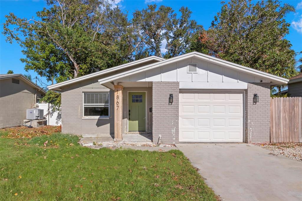 a view of a house with a yard and garage