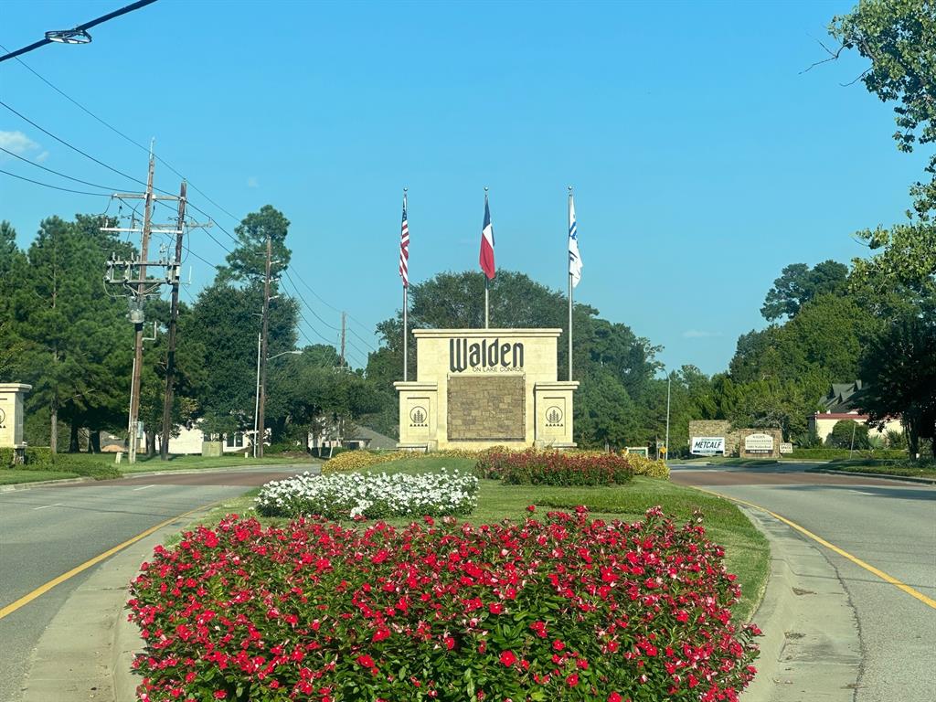 a sign that is sitting in front of flowers