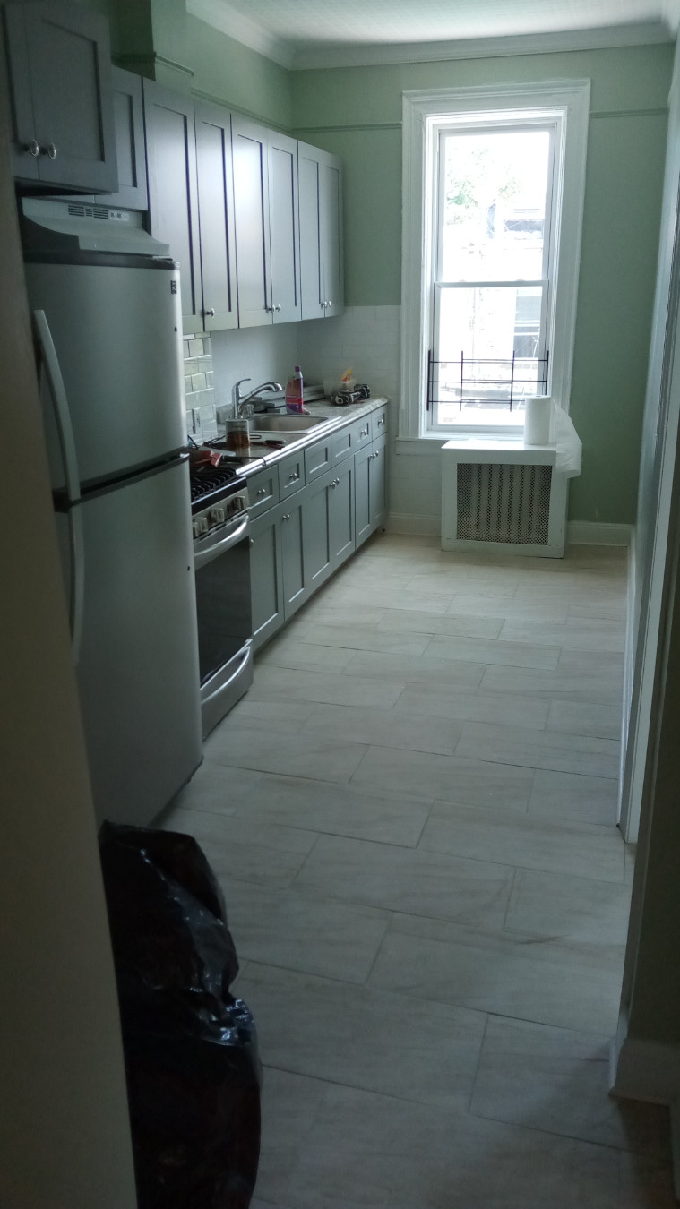 a kitchen with a refrigerator and a stove