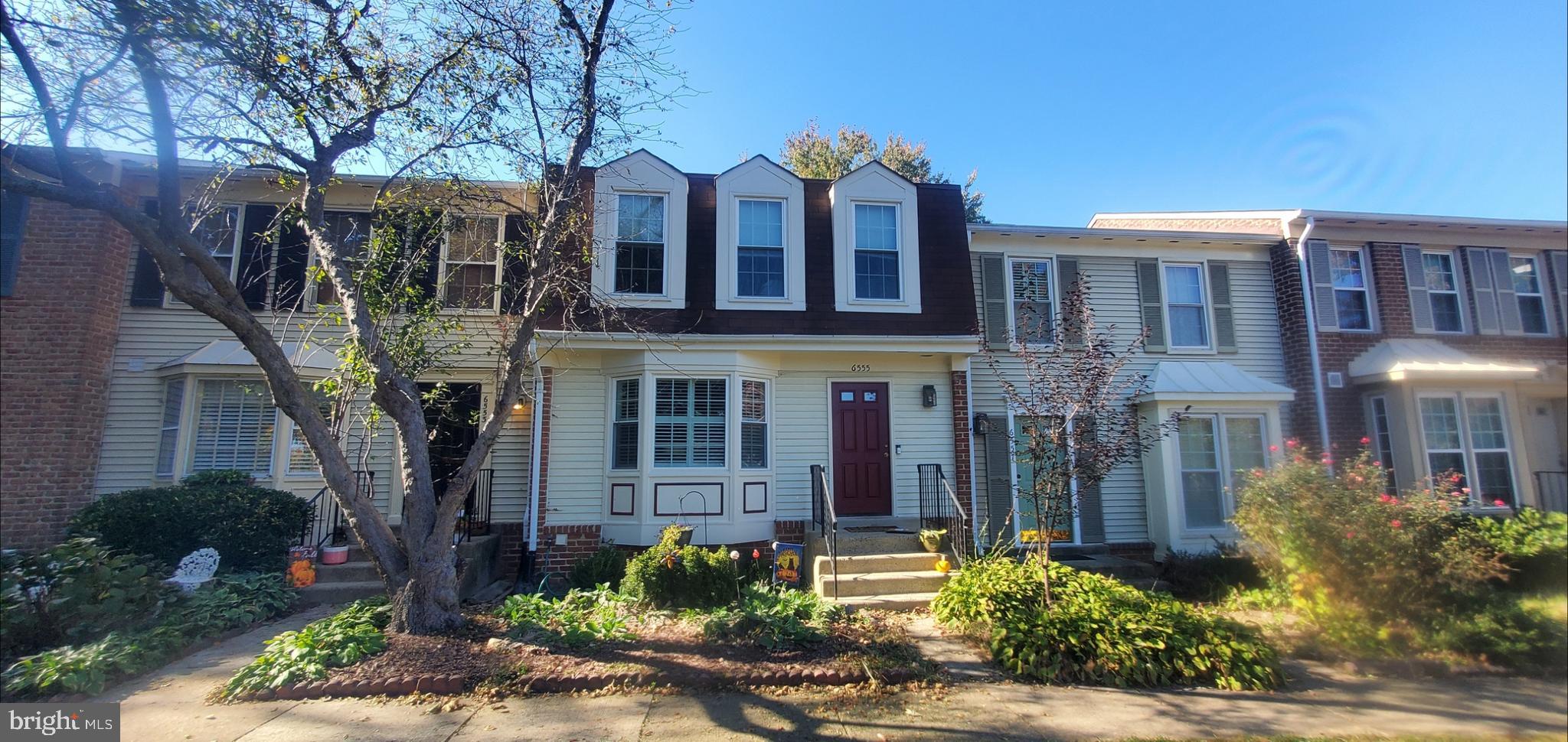 a front view of a residential apartment building with a yard