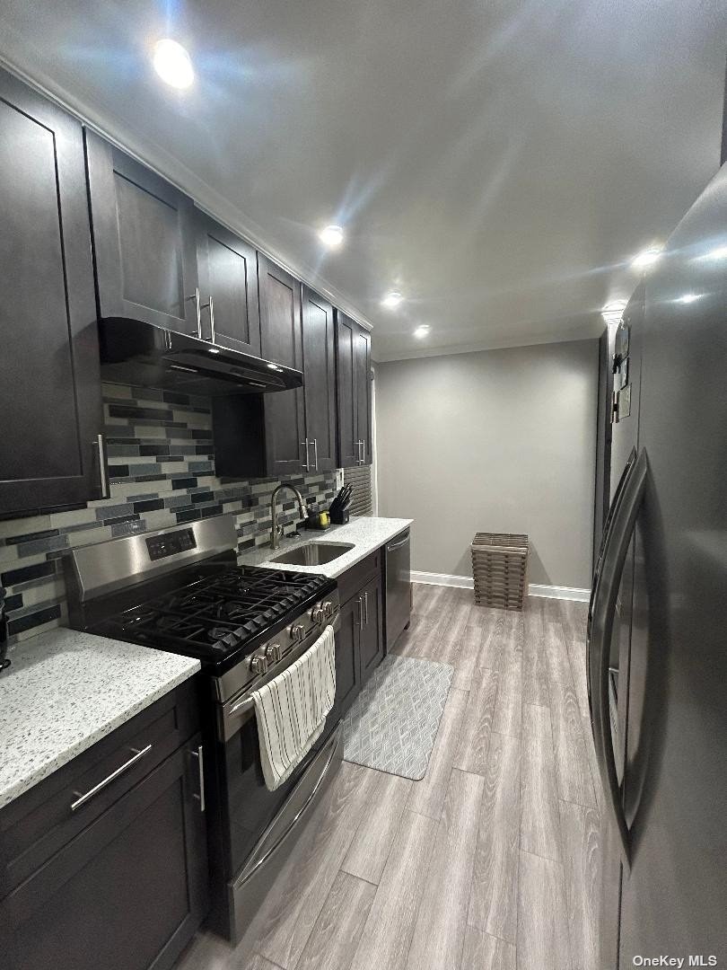 a kitchen with stainless steel appliances a sink stove and refrigerator