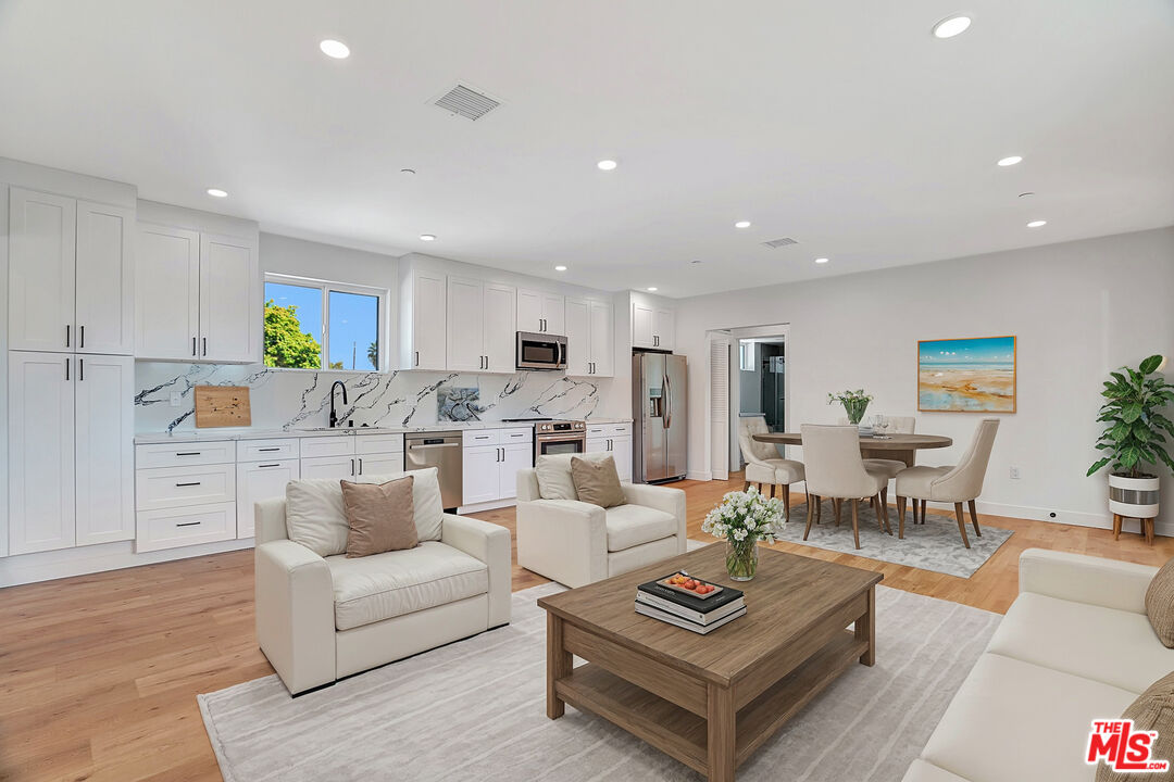 a living room with furniture kitchen and a table