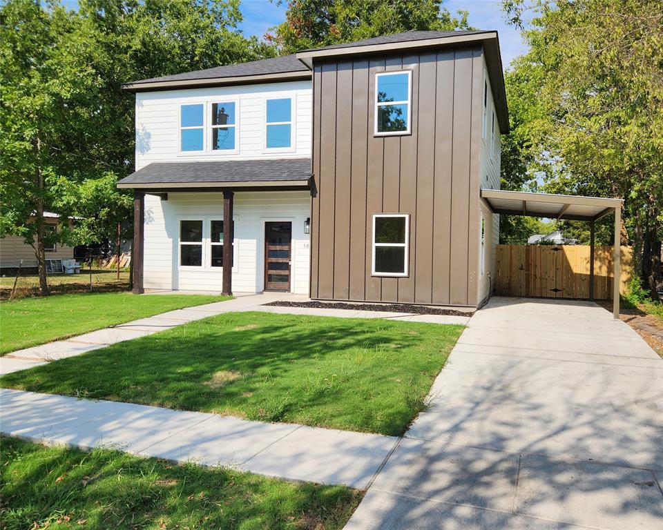 a front view of a house with a yard and a garage