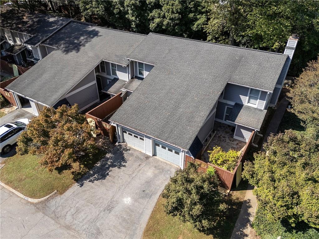 an aerial view of a house with a yard and potted plants