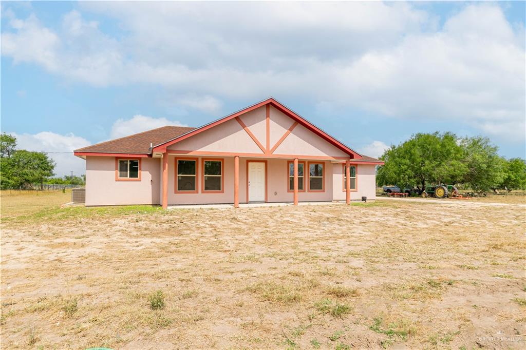 a house with yard and wooden fence