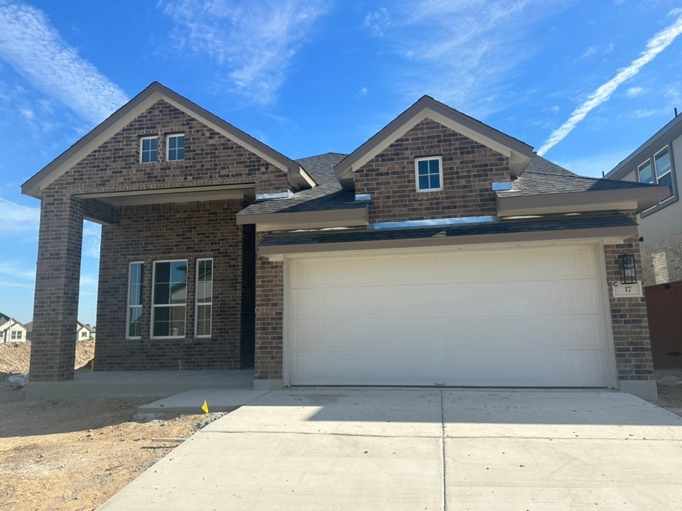 a front view of a house with garage