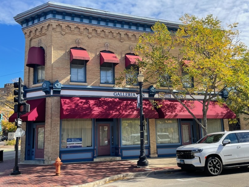 a view of building with retail shops