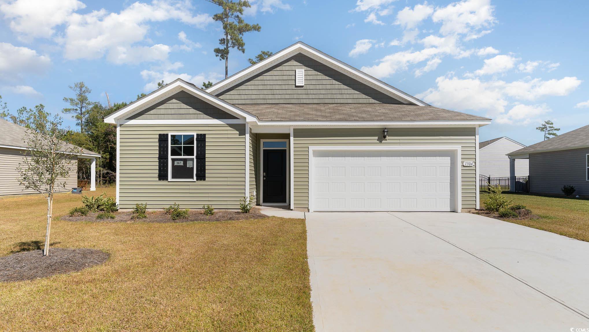 View of front of property featuring a garage and a