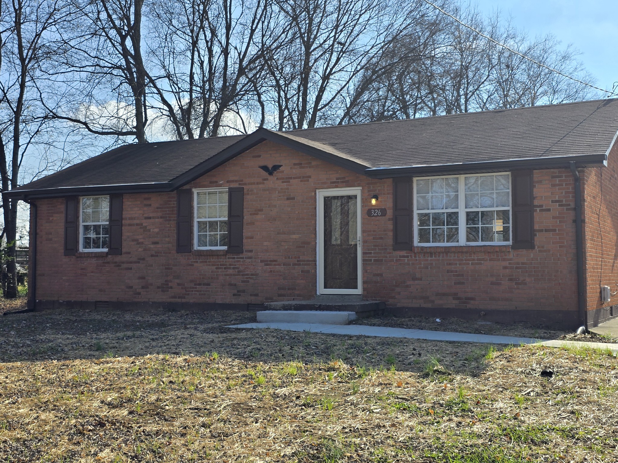 a front view of a house with a yard