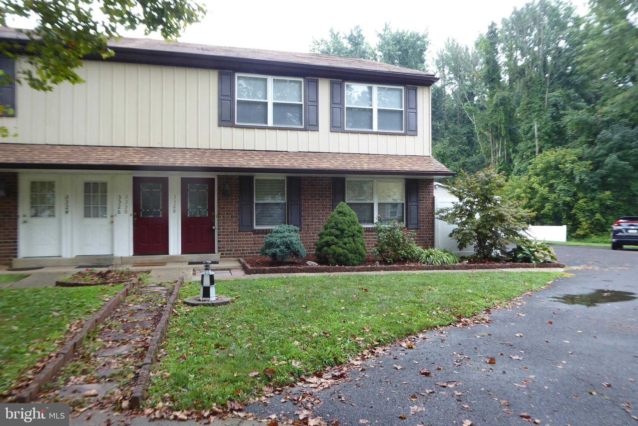 a front view of a house with garden and porch