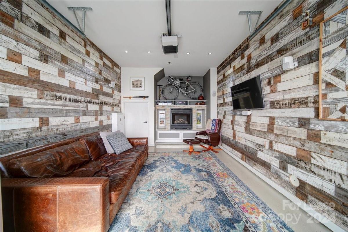 a living room with fireplace furniture and a flat screen tv