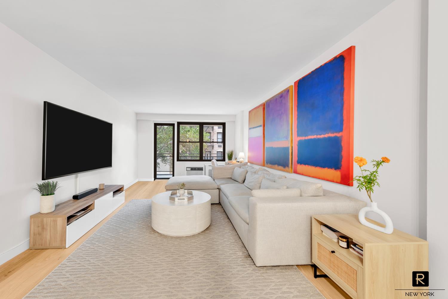 a living room with furniture and a flat screen tv