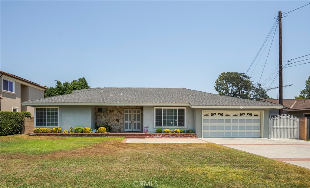 a front view of a house with a garden and porch