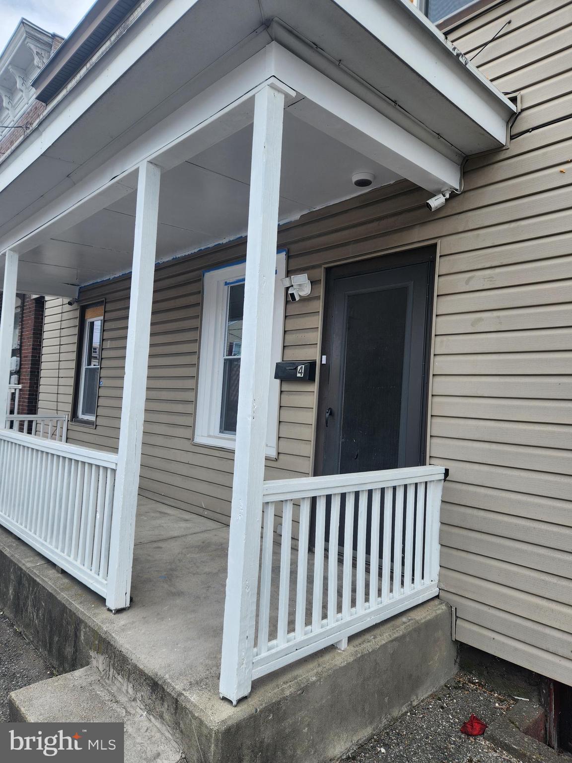 a view of a porch with a door and wooden floor