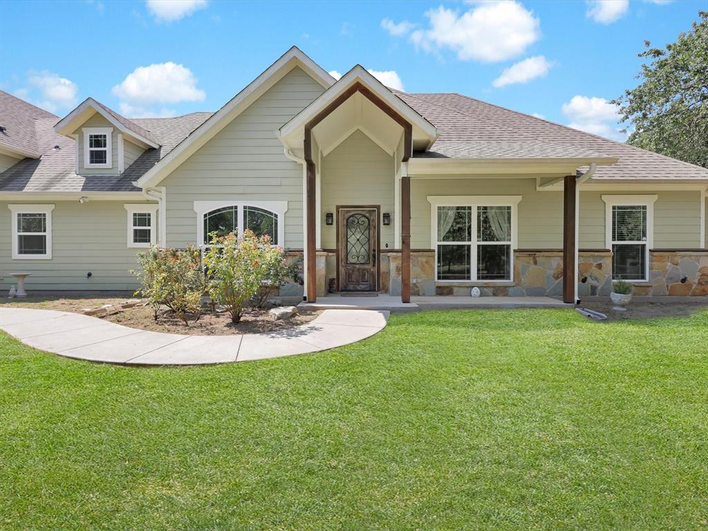 a view of a house with a yard patio and front view of a house