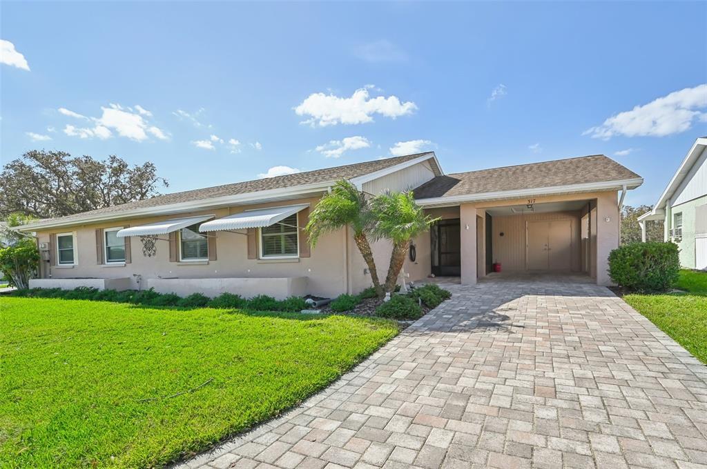 a front view of a house with a yard and garage