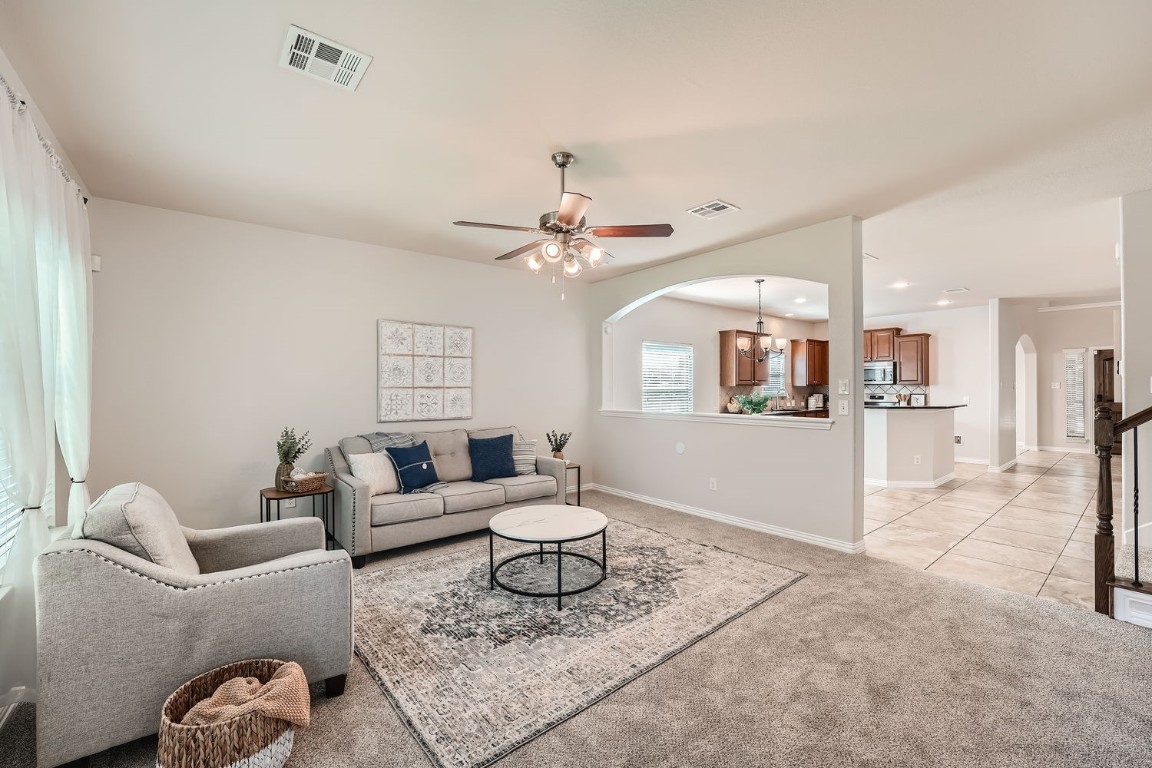 a living room with furniture and kitchen view