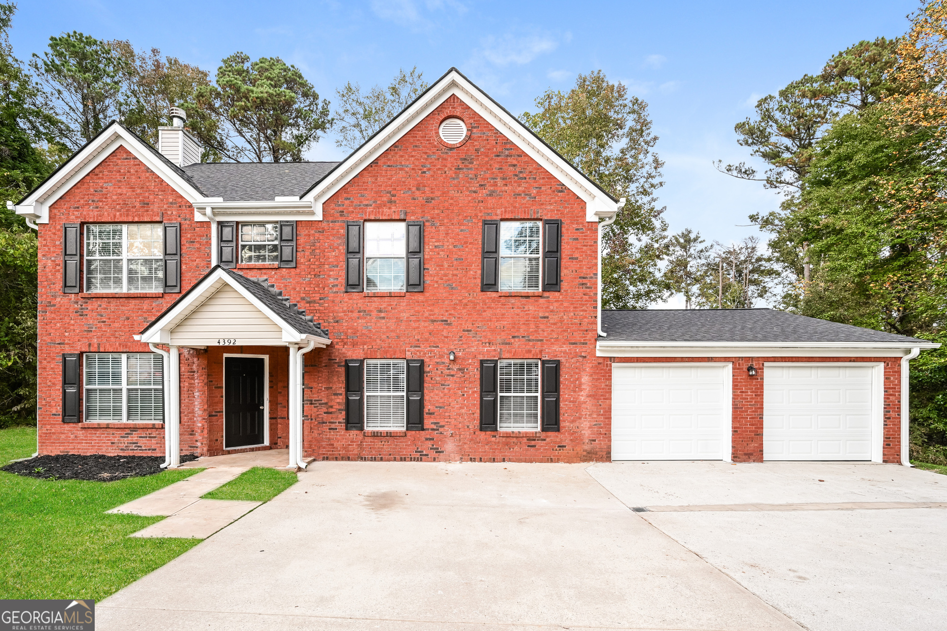 a front view of a house with yard