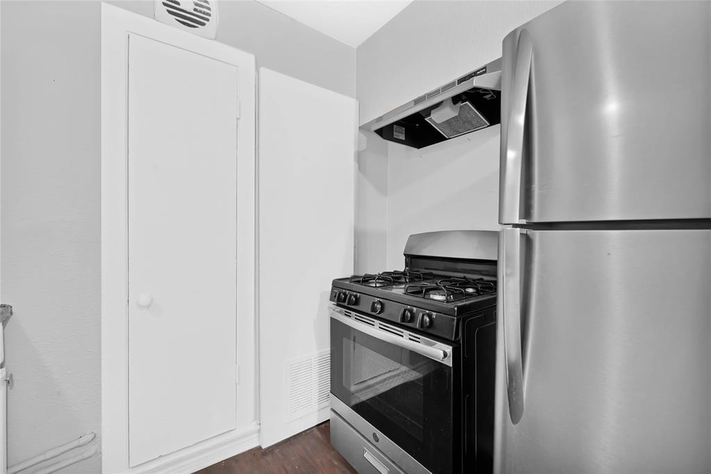 a kitchen with a stove and a refrigerator