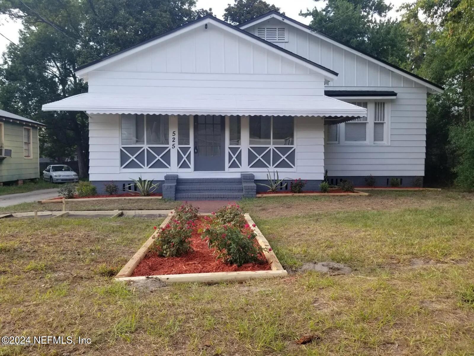 a front view of a house with garden