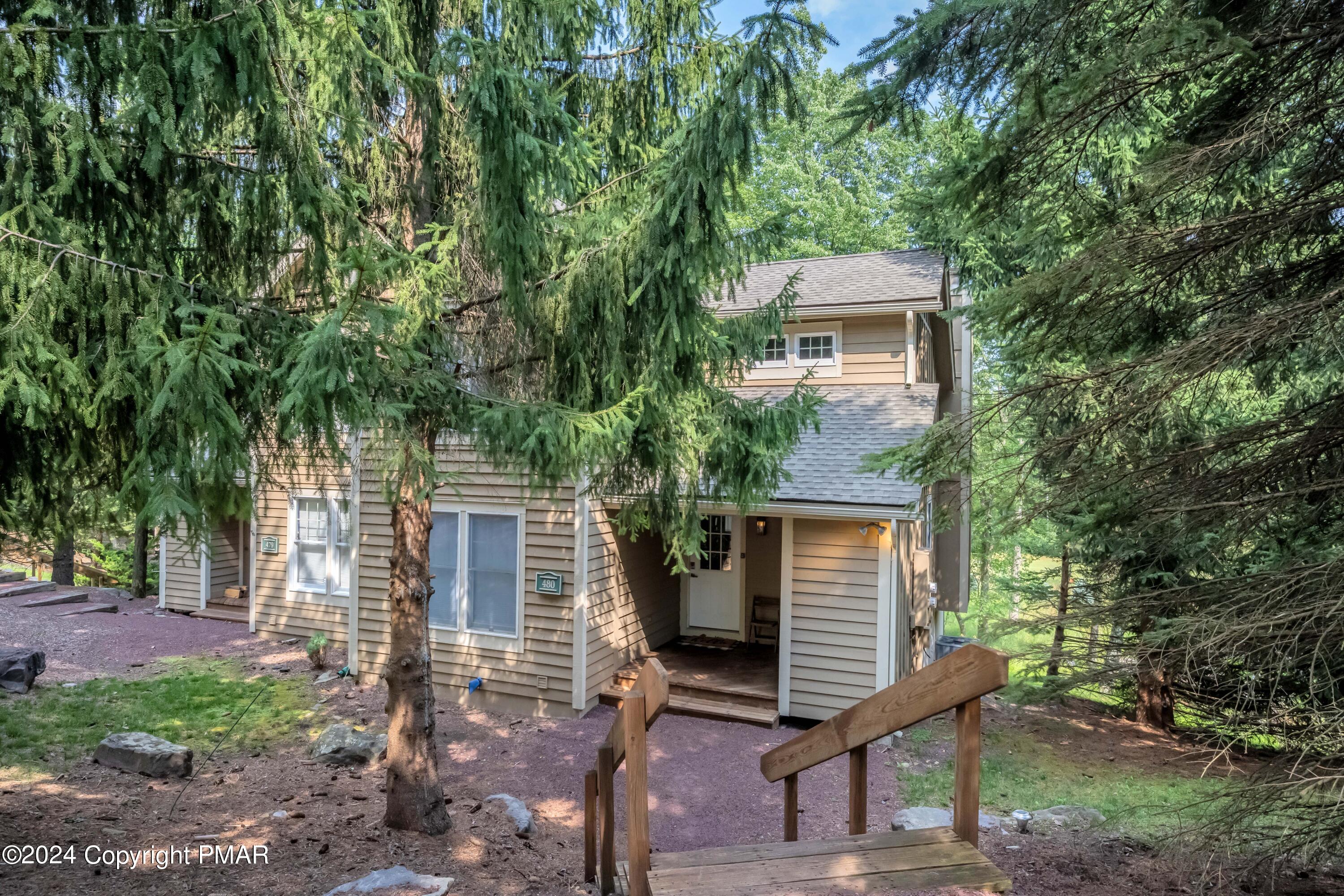 front view of a house with a tree