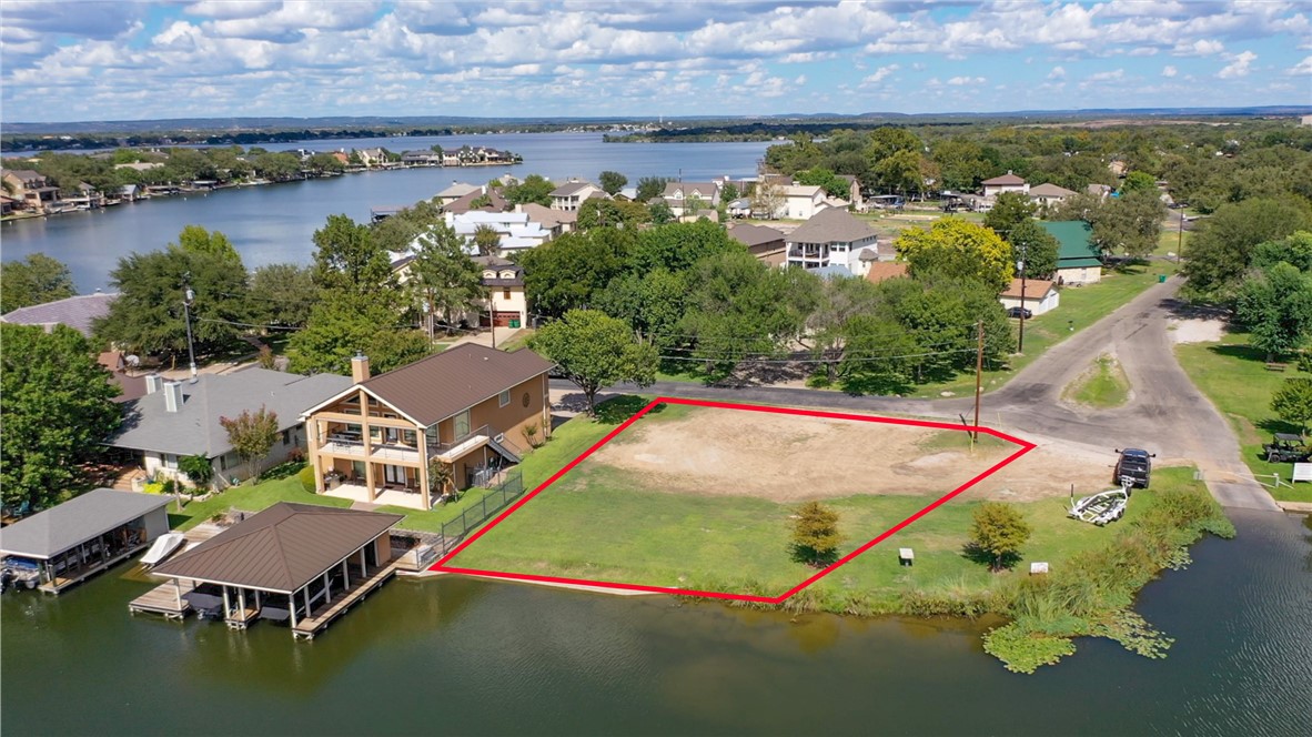 an aerial view of a house with a swimming pool and outdoor seating