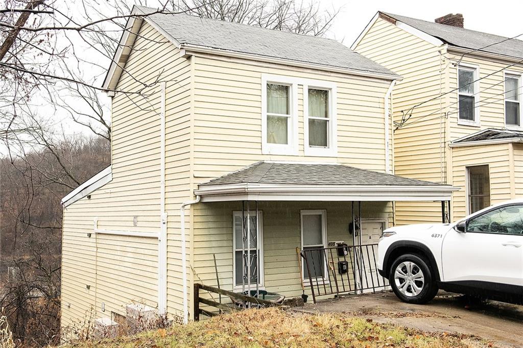 a front view of a house with parking space