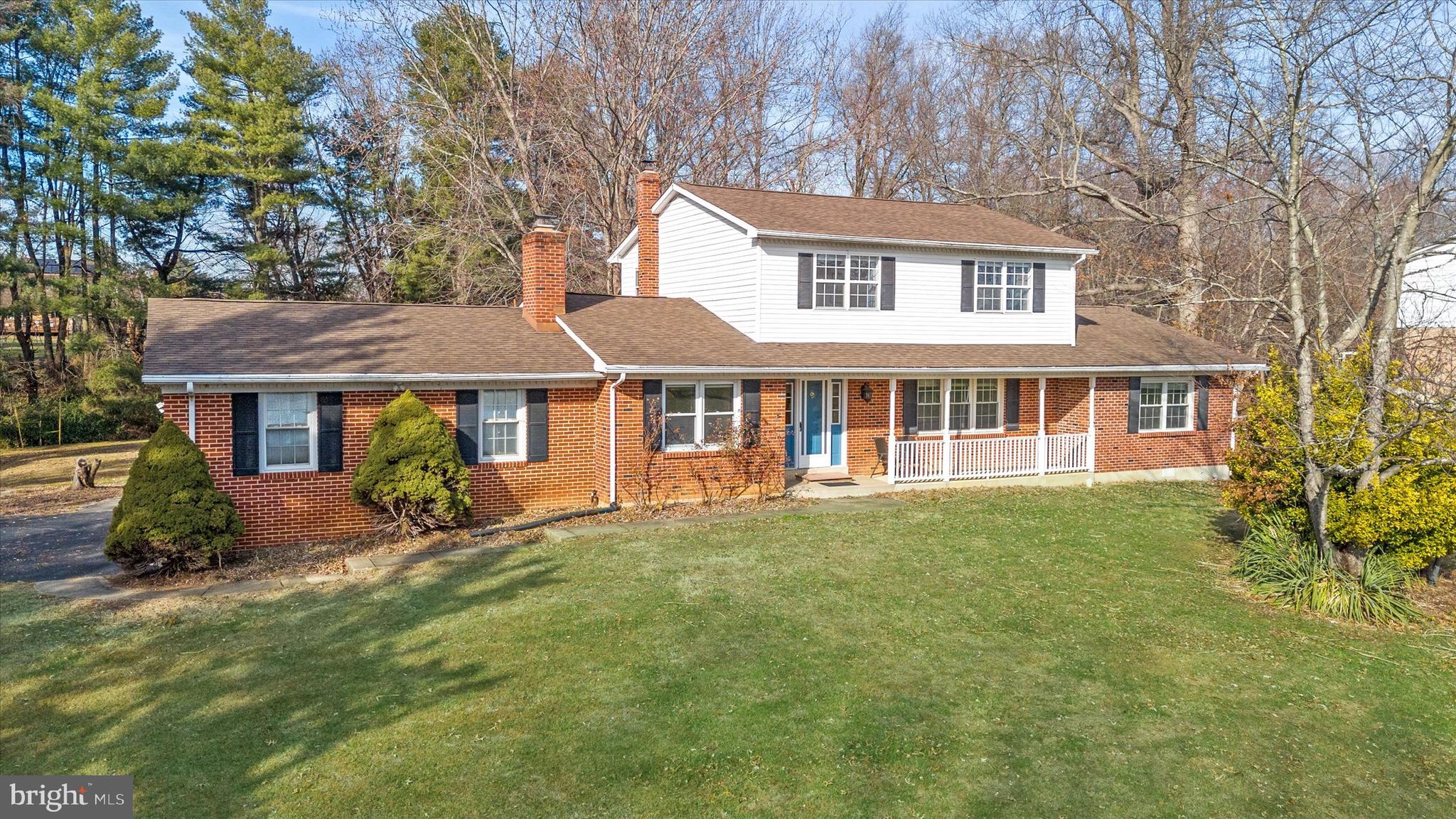 a view of a house with a yard patio and sitting area