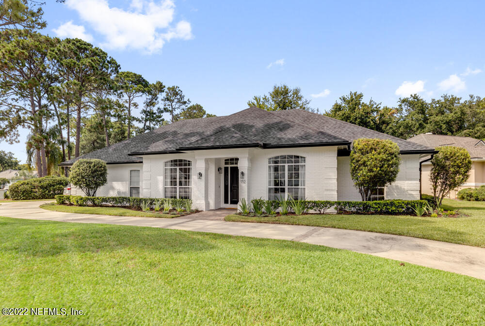 a front view of house with yard outdoor seating and green space