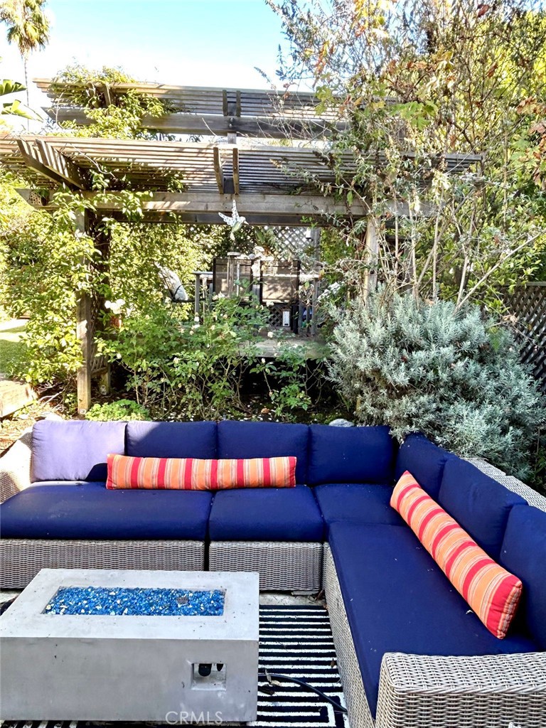 a view of a balcony with plants and outdoor seating