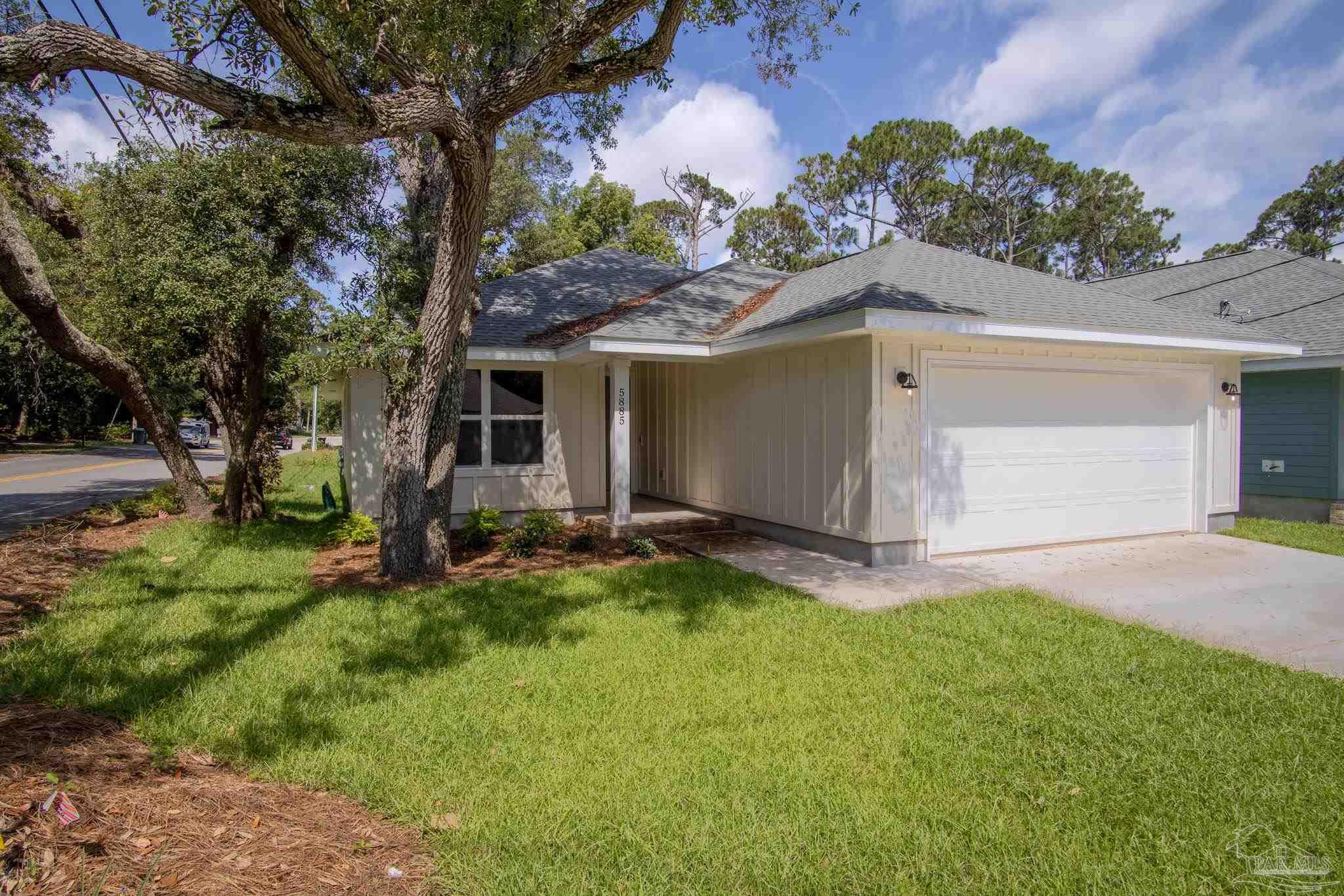 a view of a house with a yard and garage