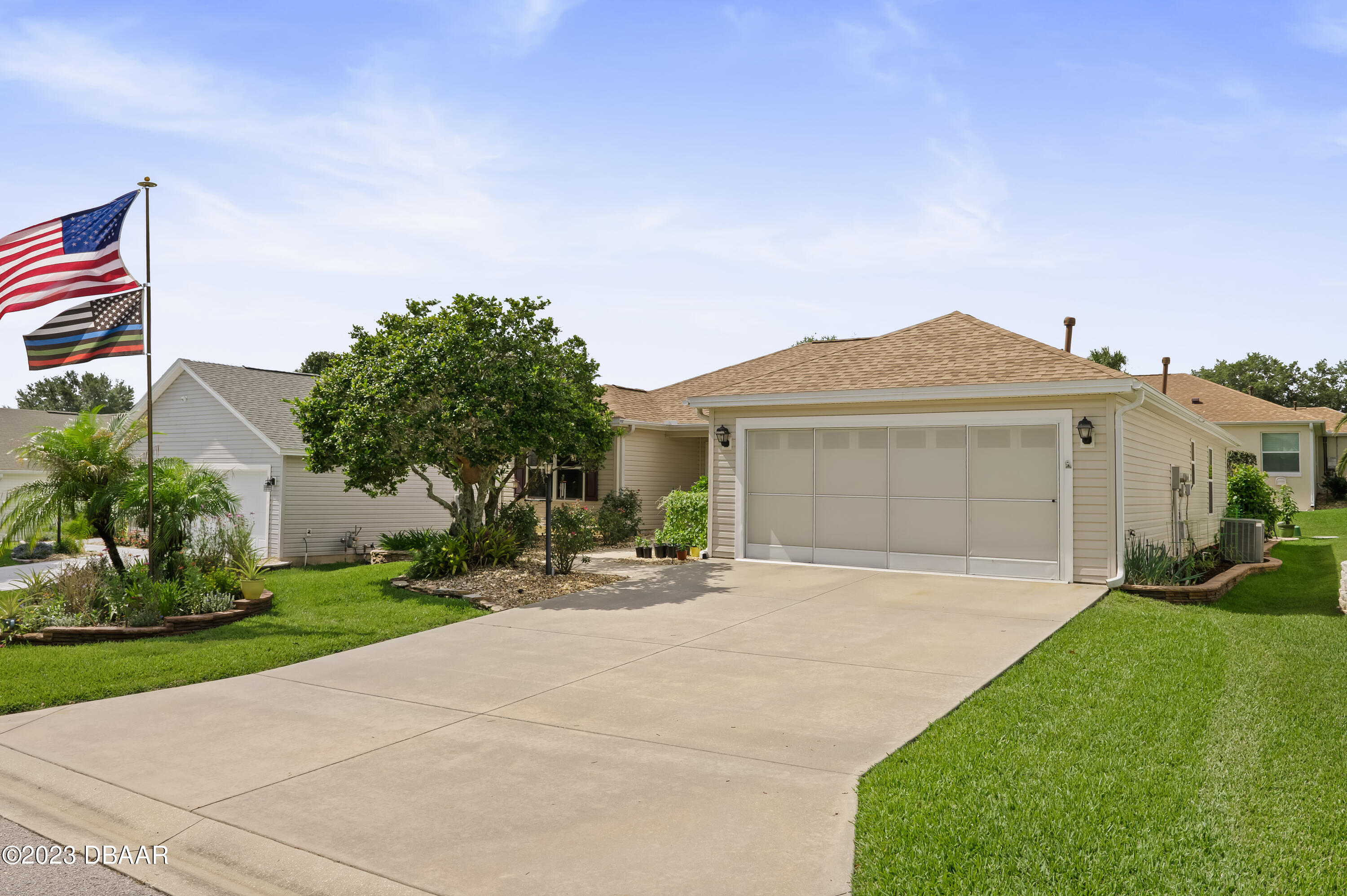 a front view of a house with a garden and yard