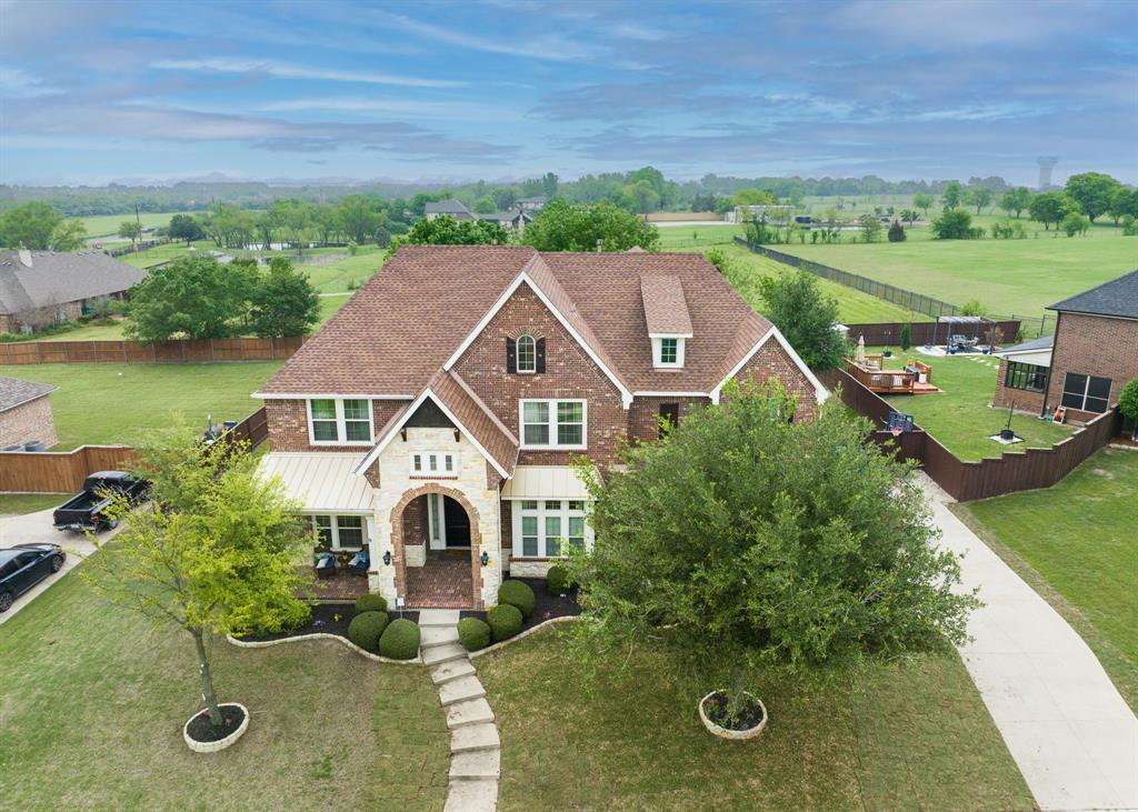 an aerial view of a house with a big yard