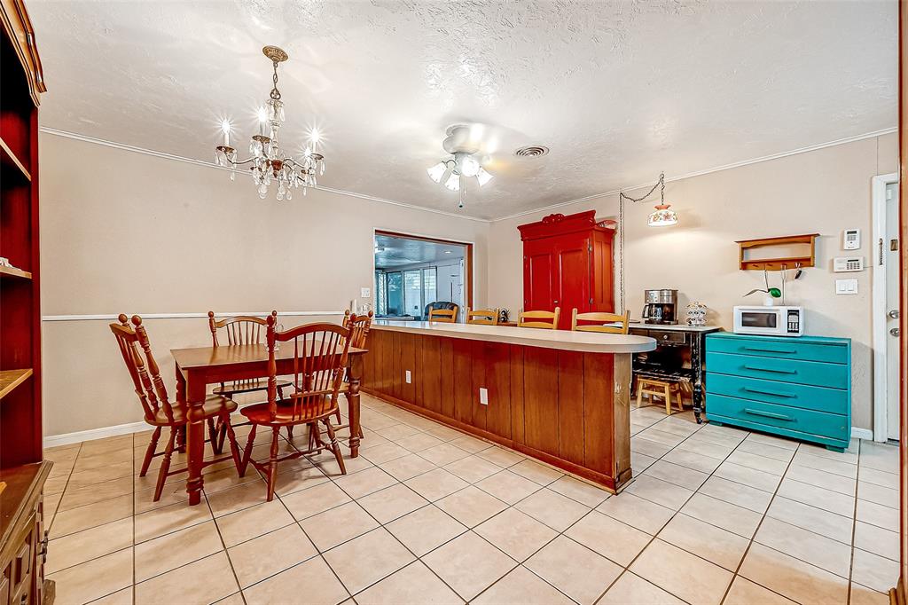 Spacious dining area with expansive bar seating and ample built-in storage.