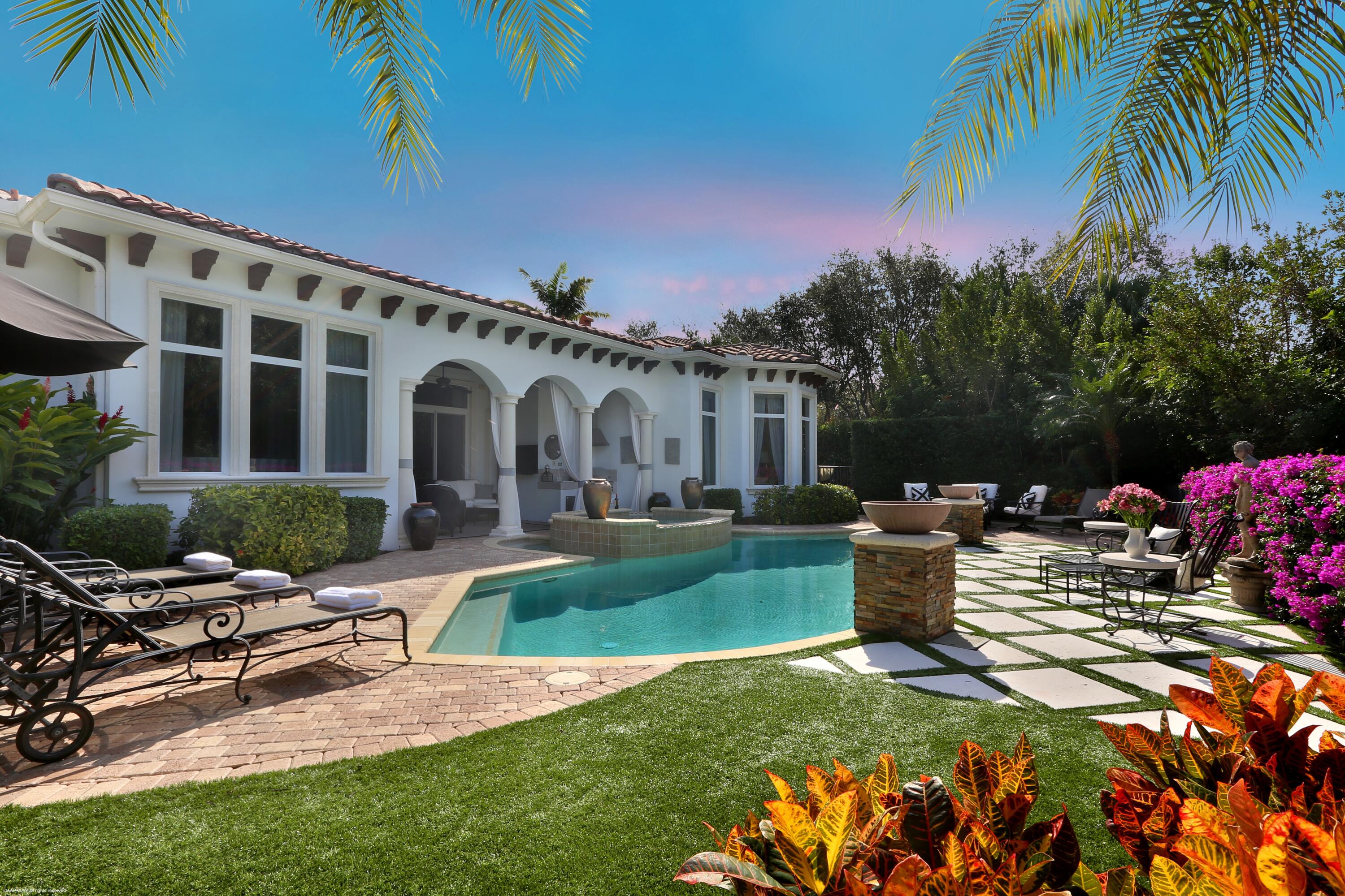 a view of a house with backyard sitting area and swimming pool