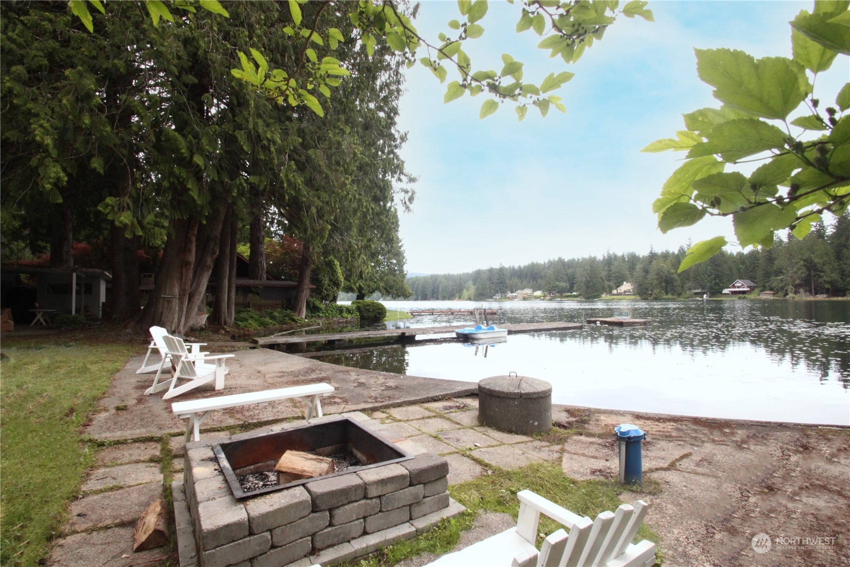 a view of swimming pool with outdoor seating and lake